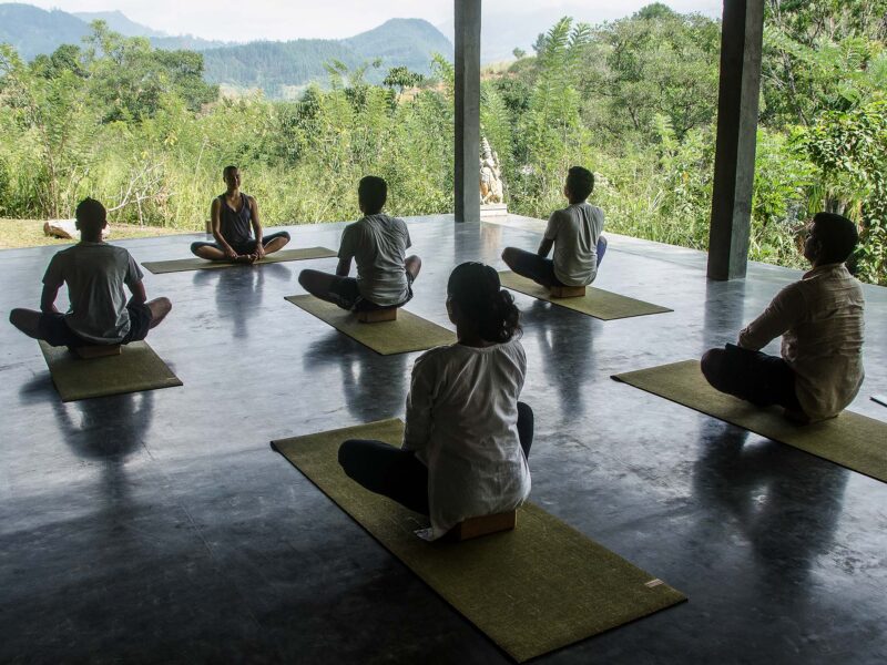 A yoga instructor hosting a wellness retreat at Santani Wellness Kandy.